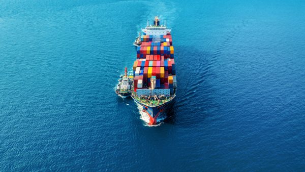 Aerial view of cargo ship with cargo container on sea.
